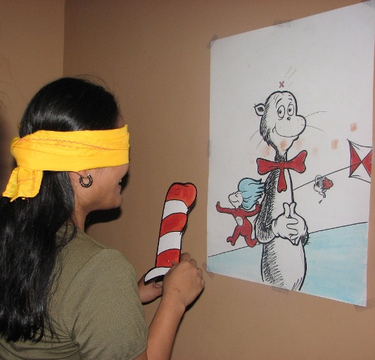 Marie trying her hand at Pin the Hat on the Cat